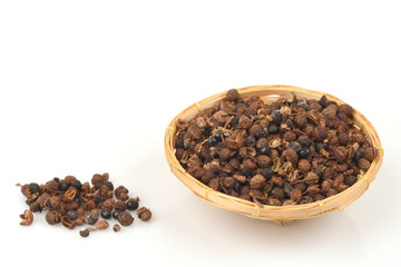 Sichuan Pepper (Chinese Pepper) spices, medicinal properties in a basket on a white background.
