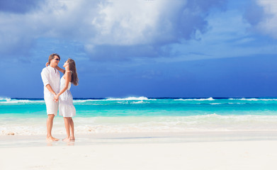 Fototapeta na wymiar happy romantic young couple walking at the beach