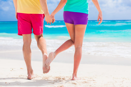 legs of young lovely couple on tropical turquoise barbados beach