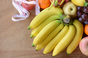 Fototapeta na wymiar fruit lose weight on wooden background