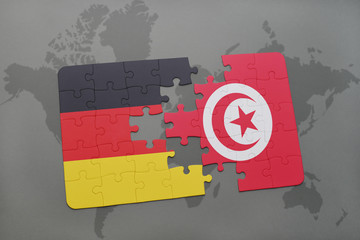 puzzle with the national flag of germany and tunisia on a world map background.