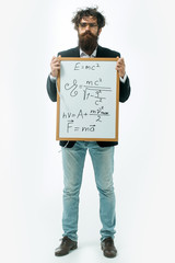 bearded man with einstein formula and newtons law