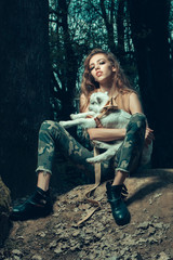 Fototapeta na wymiar Stylish girl with goat in forest