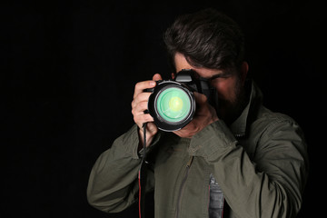 Man takes picture. Close up. Black background