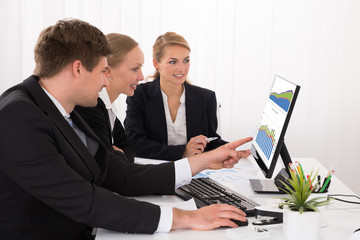 Fototapeta premium Businesspeople Working On Graphs In Office