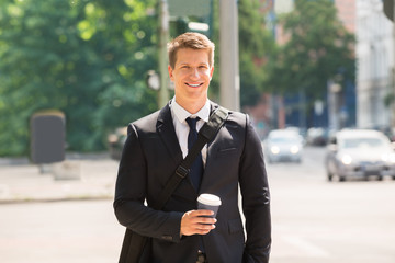Young Businessman Walking On Street
