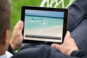 Man Watching Video On Digital Tablet