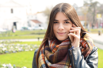 Portrait of a young woman outdoors.