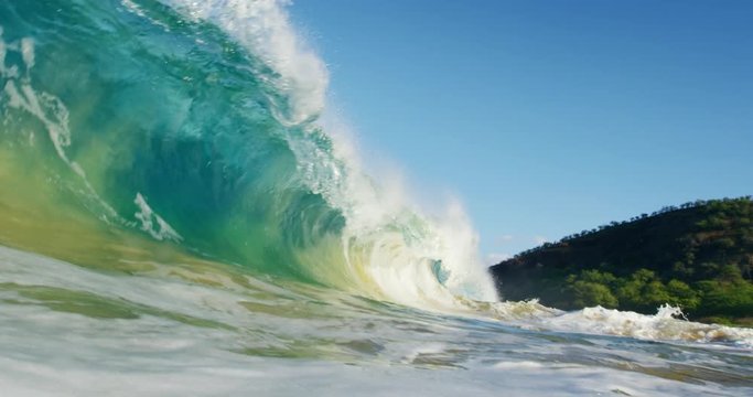 Beautiful blue ocean wave breaking in slow motion