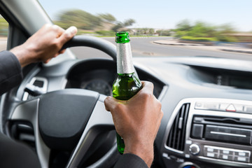 Businessman Holding Beer While Driving Car