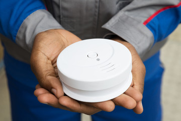 Electrician Holding Smoke Detector
