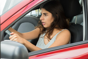 Fototapeta na wymiar Shocked Woman Sitting Inside Car