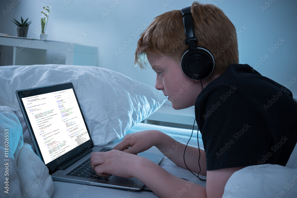 Poster boy programming on laptop