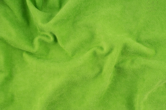 Green wrinkled fabric texture.
