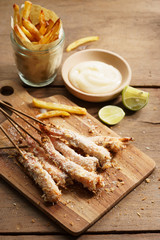 crumbed prawn skewers with potato fries