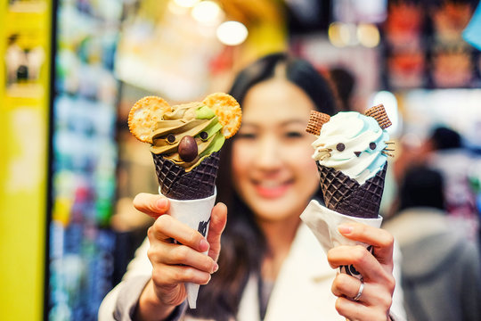 Asian Young Woman Enjoy Eating Ice Cream Cones In A Fashionable Style In Hong Kong