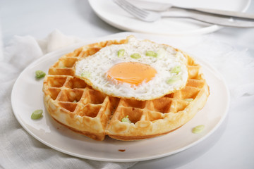 warm waffle with fried egg for breakfast.