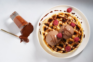 waffles with melt chocolate ice cream and chocolate sauce