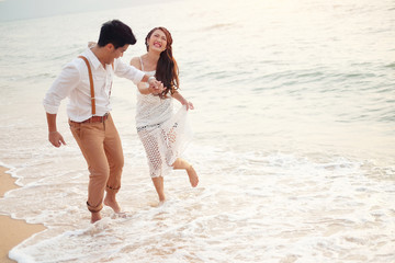 Sweet young couple having a wonderful time on the beach