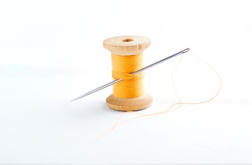 spool of thread and a needle