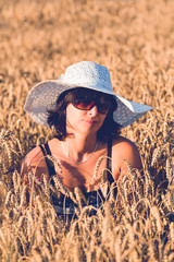 Middle aged beauty woman in wheat field