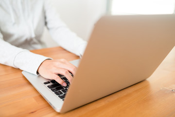 Woman using laptop computer at home