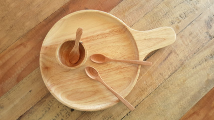 plate cup and spoon empty make with wooden top view on wooden background
