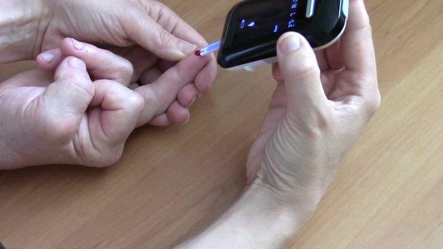 Woman performs home glucometer
