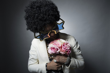Man of Afro hair that has a bouquet of flowers