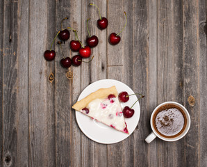 Slice of homemade cherry pie and cup of coffee with fresh cherri