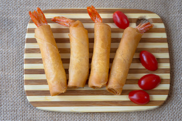 crispy shrimp creamcheese rolls with fresh salad for background