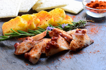 Delicious Galician octopus (Pulpo a la gallega or Pulpo a Feira) served with potatoes and hot pepper. Typical spanish tapas.