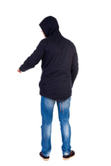 Naklejka premium Back view of pointing young men in parka. Young guy gesture. Rear view people collection. backside view of person. Isolated over white background. The guy while wearing a hood on his head is