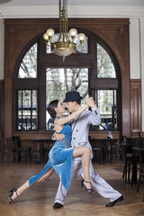 Passionate Tango Dancers Performing In Restaurant - obrazy, fototapety, plakaty