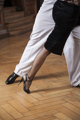 Low Section Of Tango Dancers Performing On Hardwood Floor