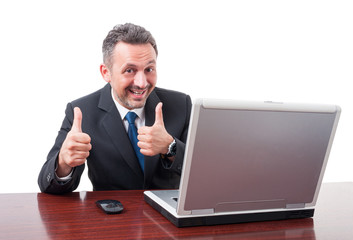 Happy businessman at office with double like gesture