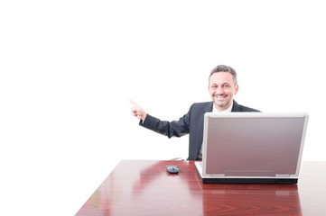Cheerful businessman poiting on copyspace