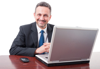 Fototapeta na wymiar Confident businessman standing in front of his computer