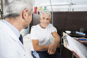 Senior Patient Looking At Doctor In Rehab Center