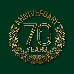 Golden emblem of seventieth years anniversary. Celebration patterned logotype with shadow on green.