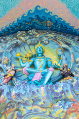 Green statue of indra on wall,colorful