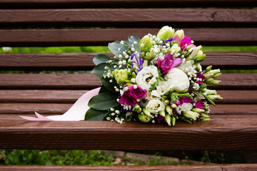 Beautiful bridal bouquet of flowers on wooden bench