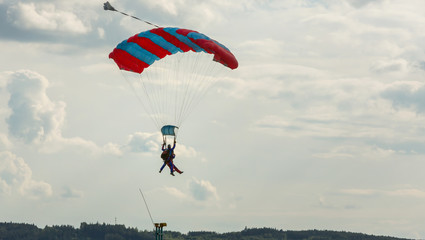 Tandem skydiving on a large parachute.