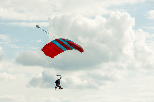 Tandem skydiving on a large parachute.