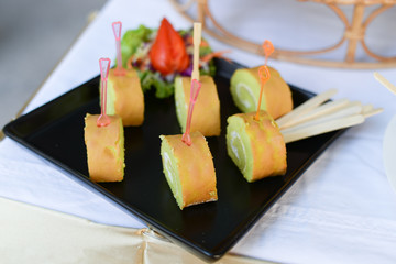 Roll cake on black plate for serve in cocktail party