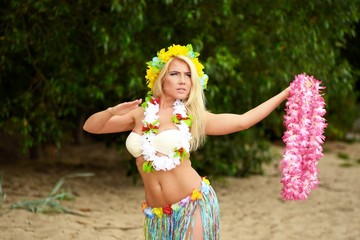 Beautyful hula hawaii dancer girl dancing on beach
