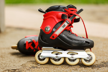 Red roller blades close-up on nature background - Powered by Adobe