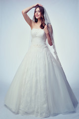 Fototapeta premium Beauty woman with wedding hairstyle and makeup. Bride fashion. Woman in white dress.