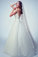 Beauty woman with wedding hairstyle and makeup. Bride fashion. Woman in white dress.