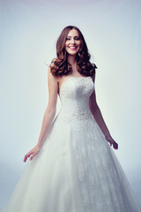 Fototapeta premium Beauty woman with wedding hairstyle and makeup. Bride fashion. Woman in white dress.